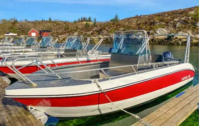 a row of boats are docked at a dock at 5 Bedroom Beautiful Home In Kverva in Kverva