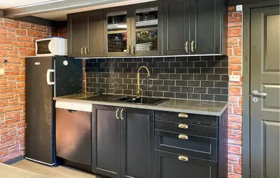a black kitchen with a sink and a refrigerator at Gorgeous Home In Kverva With Wifi in Kverva