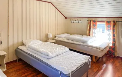 two beds in a room with wood floors at Gorgeous Home In Kverva With Wifi in Kverva