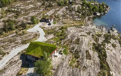 a house on the side of a rocky mountain at Lovely Home In Masfjordnes With Sauna in Masfjorden