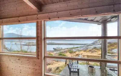 a room with windows looking out at the water at Cozy Home In Masfjordnes With Sauna in Masfjorden