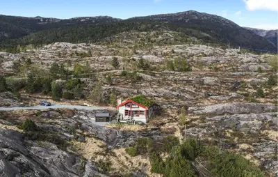 a house on the side of a mountain at Cozy Home In Masfjordnes With Sauna in Masfjorden