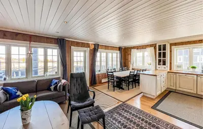 a living room with a couch and a table at Stunning Apartment In Røn With Sauna in Ron