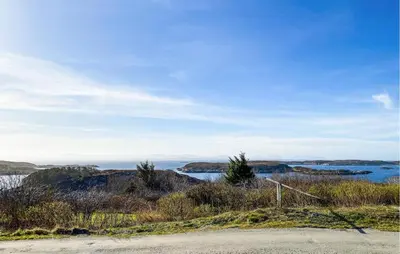 a view of the ocean from a road at Nice Home In Kverva With Wifi in Kverva