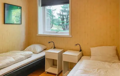 a room with two beds and a window at Nice Home In Kverva With Wifi in Kverva