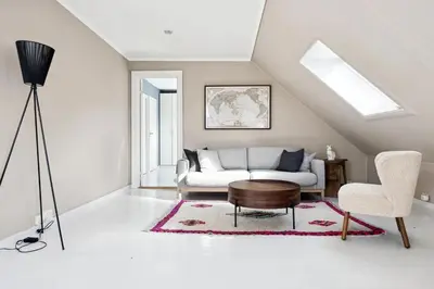 a living room with a couch and a table at Rom i loftsleilighet med utsikt in Bergen