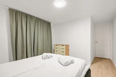 a bedroom with a bed with two towels on it at Scandinavian Design in Authentic Nordnes in Bergen
