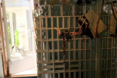 a wall of glass blocks with a rosary on it at Stay where the mountains begin in Bømlo