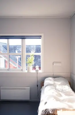 a bedroom with a bed and a window at Voss Folkehøgskule in Vossevangen