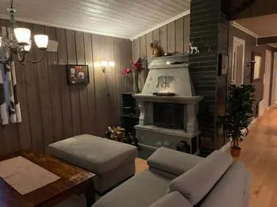 a living room with a couch and a fireplace at Skeitunet in Svingvoll