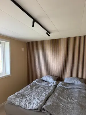a bedroom with a bed with two pillows on it at Leilighet på Harøya in Ålesund