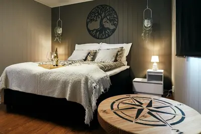 a bedroom with a large bed with a woodenokedokedokedokedokedokedoked at Home in Sylta