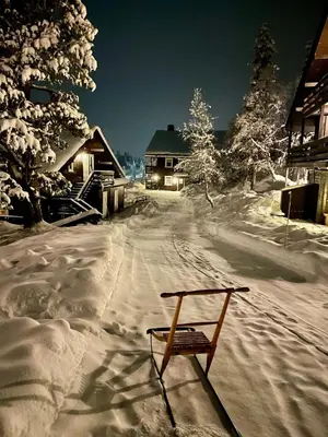 a snow covered road with a bench in front of a house at 3 Bedroom Apartment with nice view by Gaustatoppen in Gaustablikk
