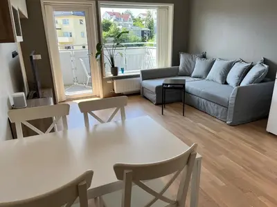a living room with a couch and a table at Nice apartment in modern complex near Old Bergen in Bergen