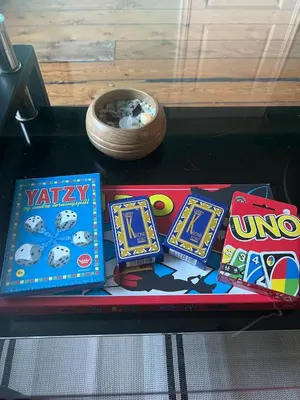 a table with some games and a bowl on it at Cozy apartment in City Center in Bergen