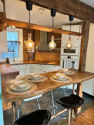 a kitchen with a wooden table with chairs at Cozy apartment in City Center in Bergen