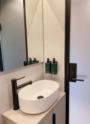 a bathroom with a white sink and a mirror at Flåm Retreat in Aurland
