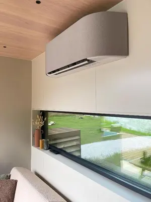 a large window in a living room with a large overhead light at Flåm Retreat in Aurland
