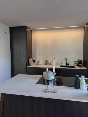 a kitchen with a table with a wine glass on it at Sental apartment in Sandviken in Bergen