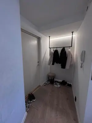 a room with a hallway with shoes and a door at Sental apartment in Sandviken in Bergen