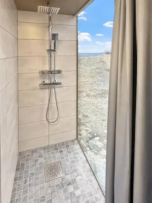 a bathroom with a shower with a view of the desert at Spegill Escape to Mirror Glass and Breathtaking Calm at 1000m in Aurdal