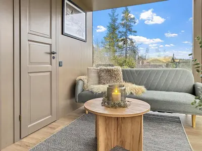 a living room with a couch and a table at Spegill Escape to Mirror Glass and Breathtaking Calm at 1000m in Aurdal