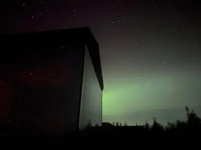 a night time view of a building in the sky at Spegill Escape to Mirror Glass and Breathtaking Calm at 1000m in Aurdal