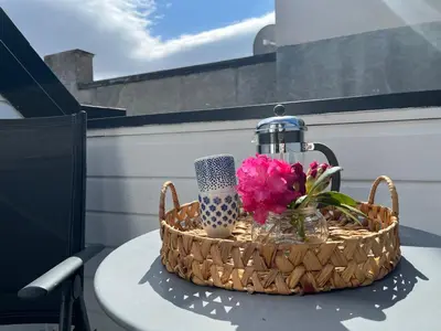 a basket sitting on a table with flowers in it at The Jugend Loft in Ålesund