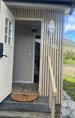 a front door of a house with a porch at Maria apartment with Sauna Otta in Otta