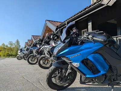 a row of motorcycles parked next to a building at Myrland Apartments in Hovet