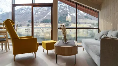 a living room with a couch and chairs and a table at Near-Sea Boat House With Panoramic Views in Sykkylven