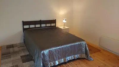 a bedroom with a bed and a lamp on a night stand at Studio apartment 48m2 in Hølera