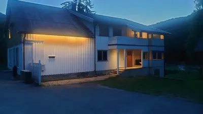 a house with lights on the side of it at Studio apartment 48m2 in Hølera