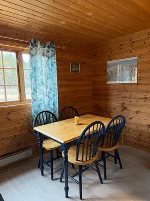 a dining room with a table and chairs in a cabin at Hafslo hytteutleige Straumane in Hafslo