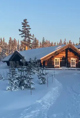 a log cabin in the winter with snow at Large and cozy family cabin with sauna in Trysil