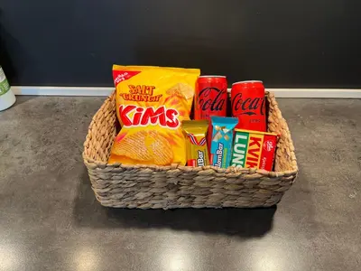 a basket filled with snacks and drinks on a floor at Nouveau Nook in Ålesund