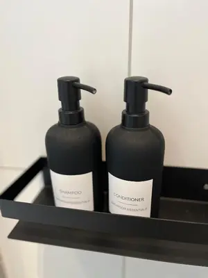 two bottles of soap sitting on a shelf at Nouveau Nook in Ålesund