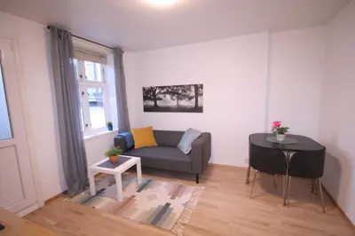 a living room with a couch and a table at Super cozy 3-bedroom in picturesque neigborhood in Bergen