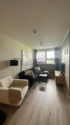 a living room with a couch and a table at One bedroom apartment close to Asker centrum in Lii