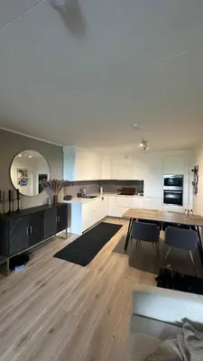 a large kitchen with a table and chairs in it at One bedroom apartment close to Asker centrum in Lii