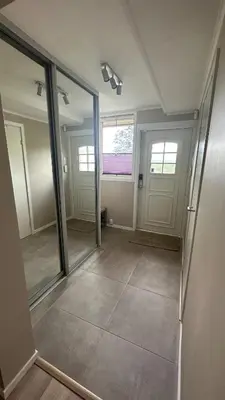 an empty room with a hallway with doors and mirrors at One bedroom apartment close to Asker centrum in Lii