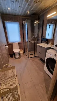 a bathroom with a toilet and a shower and a sink at Cabin Lillehammer, Nordseter, Sjusjøen in Lillehammer