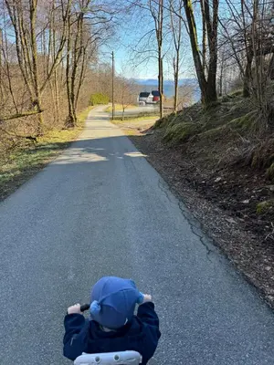 a person laying down on a road with their head down at Large villa with boathouse in Lunde