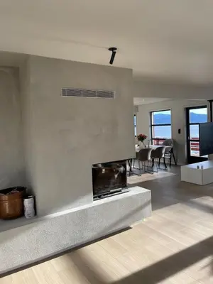 a living room with a fireplace and a dining room at Large villa with boathouse in Lunde