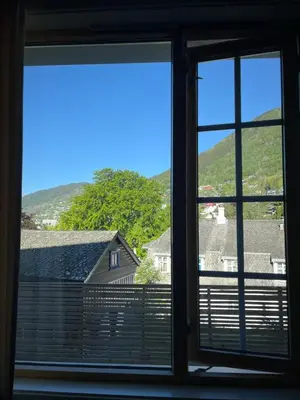 an open window with a view of houses and mountains at Ole Bull Akademiet in Vossevangen