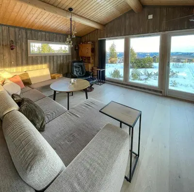 a living room with a couch and a table at Family Cabin With Views In Valdres in Reinli