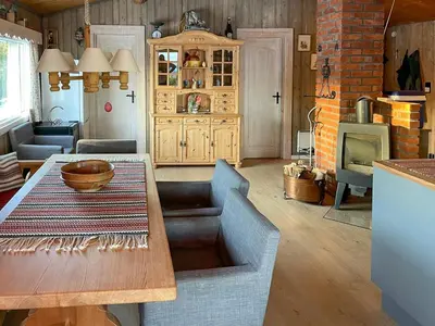a living room with a wooden table and a cabinet at Family Cabin With Views In Valdres in Reinli