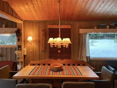 a dining room with a wooden table and chairs at Family Cabin With Views In Valdres in Reinli