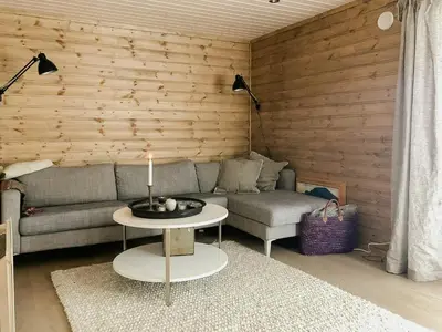 a living room with a couch and a table with a candle at Modern Cabin With Breathtaking View At Norefjell in Eggedal