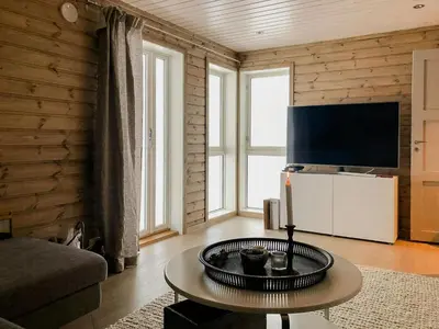 a living room with a table and a tv at Modern Cabin With Breathtaking View At Norefjell in Eggedal